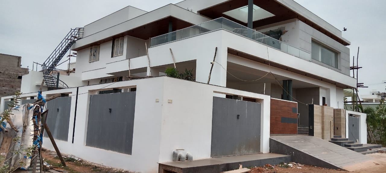 Two-storey residential villa with glass railings and terrace