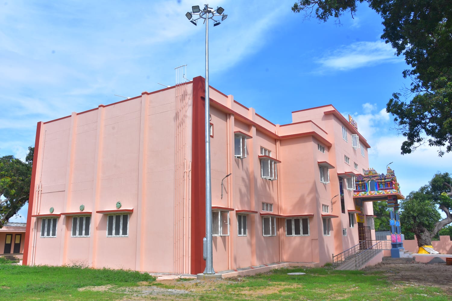 Side elevation of the temple mandapam with high-mast lighting and gopuram entrance